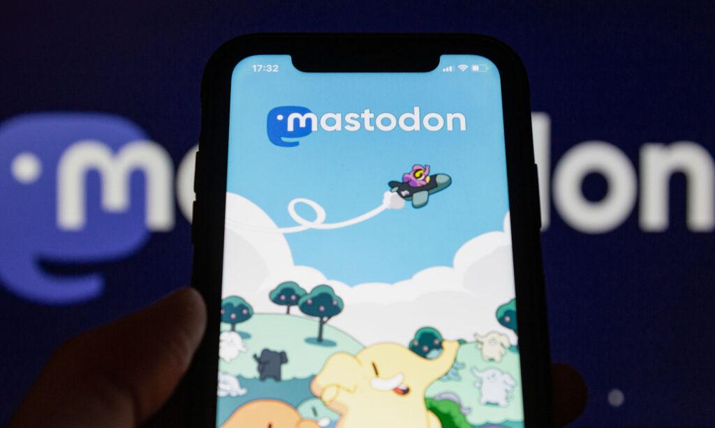 Centered, a smartphone displaying the Mastodon social media app homepage.