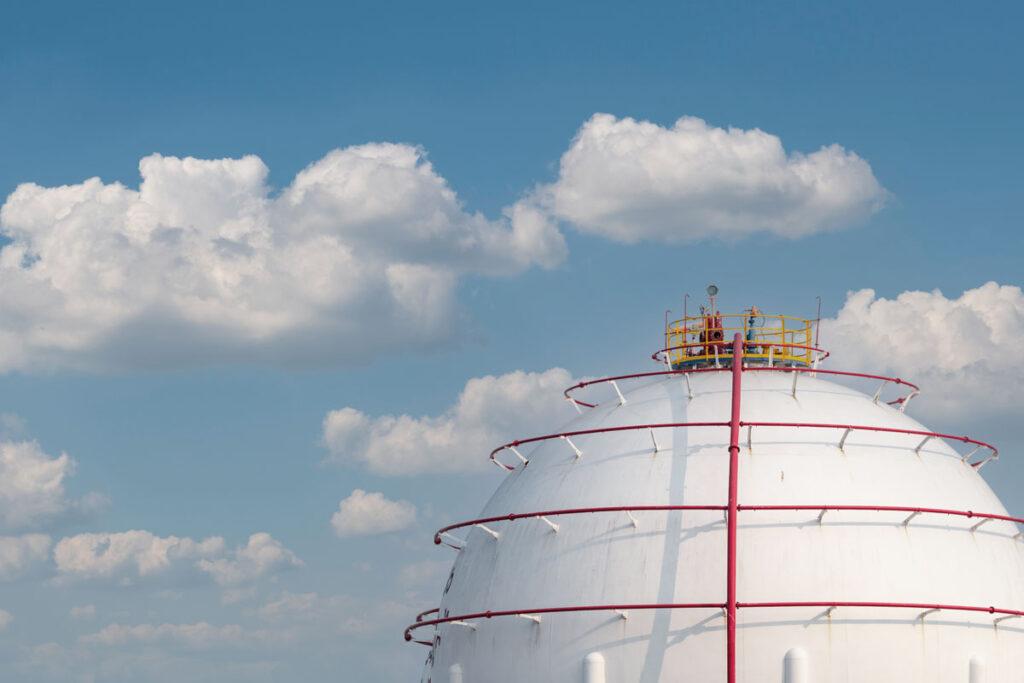 An image of an LNG (Liquified Natural Gas) tank against a blue sky.
